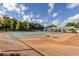 Exterior shot of some tennis courts, nets, trees, seating and a clubhouse in the background at 2547 Stony Brook Ln, Clearwater, FL 33761