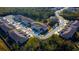 Aerial view showcasing the community's layout, buildings, parking, and verdant tree coverage at 3000 Jacob Crossing Ln, Holiday, FL 34691
