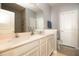 Modern bathroom featuring double sinks, granite countertops, and a tiled shower at 3000 Jacob Crossing Ln, Holiday, FL 34691