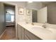 Bright bathroom with a double vanity, quartz counters, and modern fixtures at 3000 Jacob Crossing Ln, Holiday, FL 34691