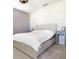 Neutral bedroom featuring a wooden bed frame and a white comforter at 3000 Jacob Crossing Ln, Holiday, FL 34691