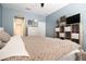 Comfortable bedroom with a large bed, dresser, and decorative elements at 3000 Jacob Crossing Ln, Holiday, FL 34691