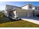 Attractive two-story home boasts a neatly landscaped front yard, and a two-car garage at 3000 Jacob Crossing Ln, Holiday, FL 34691
