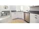 Bright kitchen showcasing white cabinetry, stainless steel dishwasher, and granite countertops at 3000 Jacob Crossing Ln, Holiday, FL 34691