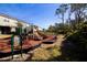 Community playground with green metal play structures, mulch ground cover and a manicured lawn at 3000 Jacob Crossing Ln, Holiday, FL 34691