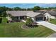 Aerial view of a well maintained house with beautiful landscaping and a two-car garage at 3276 Hilary Cir, Palm Harbor, FL 34684