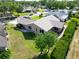 Aerial view of house with neatly manicured lawn and a lush green hedge in a quiet neighborhood at 3276 Hilary Cir, Palm Harbor, FL 34684