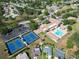 Aerial view of clubhouse amenities including tennis courts, pool, and shuffleboard courts at 3276 Hilary Cir, Palm Harbor, FL 34684