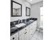 Modern bathroom featuring a double vanity with granite countertops, offering a luxurious and functional space at 3276 Hilary Cir, Palm Harbor, FL 34684