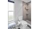 Updated bathroom with a tiled shower, sleek fixtures, and a modern toilet, creating a clean and inviting space at 3276 Hilary Cir, Palm Harbor, FL 34684