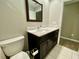 Contemporary bathroom with a marble vanity, sleek fixtures, and a modern toilet, blending style and functionality seamlessly at 3276 Hilary Cir, Palm Harbor, FL 34684