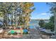 Community boat ramp leading to a lake surrounded by lush trees, with kayaks and boats nearby at 3276 Hilary Cir, Palm Harbor, FL 34684