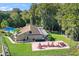 Exterior of community building and pool showing landscaping, mature trees, picnic tables, and ample green space at 3276 Hilary Cir, Palm Harbor, FL 34684