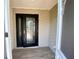 Stylish black front door featuring decorative glass detailing and a convenient keyless entry system at 3276 Hilary Cir, Palm Harbor, FL 34684