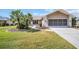 Beautiful home with palm trees and large driveway leading to the two-car garage at 3276 Hilary Cir, Palm Harbor, FL 34684