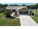 Charming single-story home with well-manicured lawn, mature palm trees, and a screened two-car garage at 3276 Hilary Cir, Palm Harbor, FL 34684