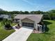 Well-maintained home with a concrete driveway and landscaped front yard, including a pergola, in a quiet neighborhood at 3276 Hilary Cir, Palm Harbor, FL 34684