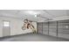 Spacious garage with sealed concrete floor, side access door, and modern garage door at 3276 Hilary Cir, Palm Harbor, FL 34684