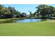 Picturesque golf course featuring a pond and well-maintained green at 3276 Hilary Cir, Palm Harbor, FL 34684