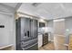Kitchen featuring modern black stainless steel refrigerator, oven, and tile backsplash at 3276 Hilary Cir, Palm Harbor, FL 34684