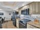 Modern kitchen featuring granite counters, sleek appliances, and ample cabinet space at 3276 Hilary Cir, Palm Harbor, FL 34684