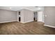 Open concept living area with wood-look floors offering ample space for entertaining and relaxing at 3276 Hilary Cir, Palm Harbor, FL 34684