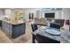 Open concept living and dining area with a large-screen TV and sliding door access to patio at 3276 Hilary Cir, Palm Harbor, FL 34684