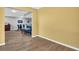 Open-concept living space with wood flooring and view to dining room at 3276 Hilary Cir, Palm Harbor, FL 34684