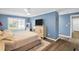 Blue bedroom featuring a window, tv and ensuite bathroom entrance at 3276 Hilary Cir, Palm Harbor, FL 34684