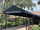 Covered main entrance provides shelter and an inviting pathway, surrounded by well-maintained landscaping at 3276 Hilary Cir, Palm Harbor, FL 34684