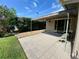 Charming covered patio with privacy hedge, perfect for enjoying outdoor living at 3276 Hilary Cir, Palm Harbor, FL 34684