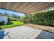 Covered patio provides a relaxing outdoor space overlooking the lush, green backyard at 3276 Hilary Cir, Palm Harbor, FL 34684