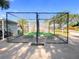Golf practice facility with putting area, netting enclosure, and ranger cart at 3276 Hilary Cir, Palm Harbor, FL 34684