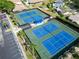 Aerial view of community tennis courts featuring multiple well-maintained blue courts with green surroundings at 3276 Hilary Cir, Palm Harbor, FL 34684