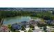 Aerial view of a neighborhood featuring a pond, lush greenery, and well-maintained homes at 33176 Whisper Pointe Dr, Wesley Chapel, FL 33545