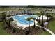Aerial view of a luxury resort-style pool surrounded by palm trees, lounge chairs, and manicured landscaping at 33176 Whisper Pointe Dr, Wesley Chapel, FL 33545