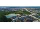 Aerial view of a neighborhood featuring a pond, lush greenery, and well-maintained homes at 33176 Whisper Pointe Dr, Wesley Chapel, FL 33545