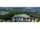 Aerial view of a neighborhood featuring a pond, lush greenery, and well-maintained homes at 33176 Whisper Pointe Dr, Wesley Chapel, FL 33545