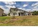 Large backyard with a grassy lawn and a view of neighboring homes at 33176 Whisper Pointe Dr, Wesley Chapel, FL 33545