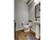 A half-bath featuring hardwood floors and a decorative rug at 33176 Whisper Pointe Dr, Wesley Chapel, FL 33545