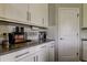 Coffee bar with stainless steel appliances, white subway tile, and bright white cabinets at 33176 Whisper Pointe Dr, Wesley Chapel, FL 33545