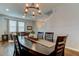 Elegant dining room featuring a dark wood table, stylish chandelier, and hardwood floors at 33176 Whisper Pointe Dr, Wesley Chapel, FL 33545