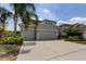 Charming home featuring a three-car garage, well-manicured landscaping, and inviting curb appeal at 33176 Whisper Pointe Dr, Wesley Chapel, FL 33545