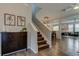 Bright foyer featuring hardwood floors, stylish staircase, and decor throughout the shared living space at 33176 Whisper Pointe Dr, Wesley Chapel, FL 33545