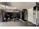 Home gym inside the garage with a variety of weights and machines at 33176 Whisper Pointe Dr, Wesley Chapel, FL 33545