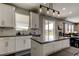 Bright kitchen featuring white cabinets, an island, and modern pendant lighting at 33176 Whisper Pointe Dr, Wesley Chapel, FL 33545