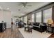 Inviting living area featuring hardwood flooring, modern furniture, and seamless flow into the kitchen at 33176 Whisper Pointe Dr, Wesley Chapel, FL 33545
