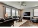 Spacious living room featuring hardwood floors, modern decor and a comfortable seating arrangement at 33176 Whisper Pointe Dr, Wesley Chapel, FL 33545