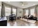 Inviting living room with hardwood floors, large windows, and stylish decor, creating a cozy ambiance at 33176 Whisper Pointe Dr, Wesley Chapel, FL 33545