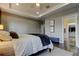 A view of the main bedroom with a walk-in closet and features neutral walls, tray ceiling, and hard wood floors at 33176 Whisper Pointe Dr, Wesley Chapel, FL 33545